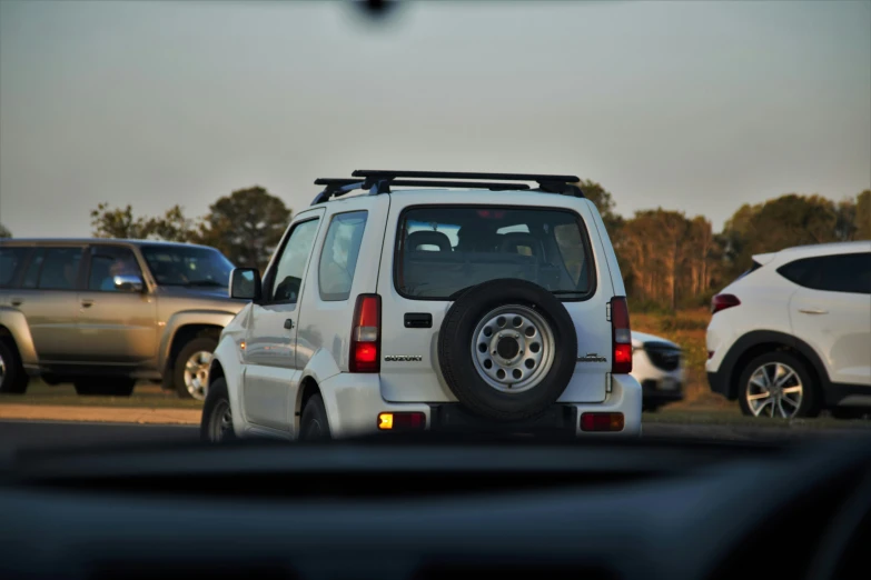 the rear tire on a white jeep is missing and looking downward