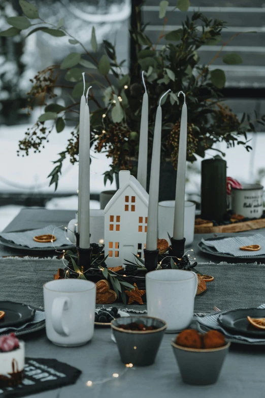 a table with a bunch of cups and dishes on it