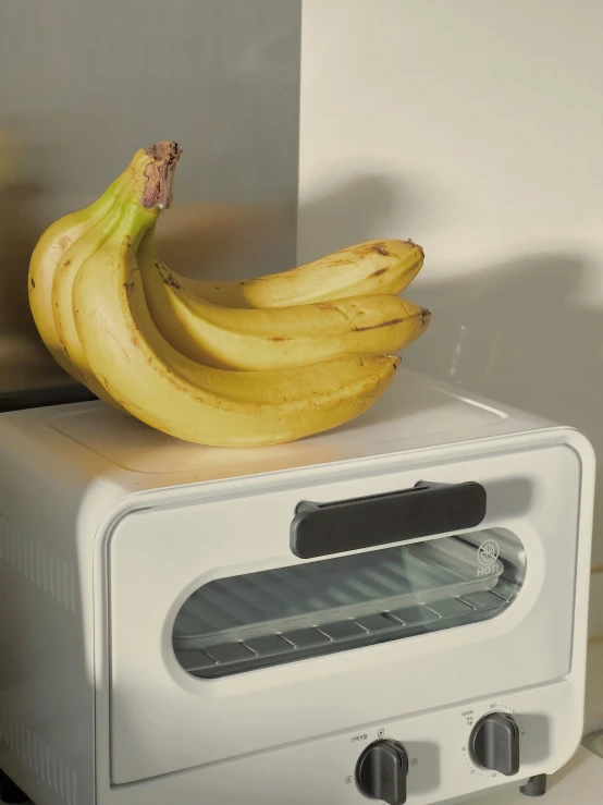 a banana sitting on top of a toaster oven