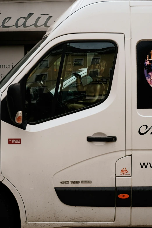 a van with a queen sitting inside and advertising the royal wedding