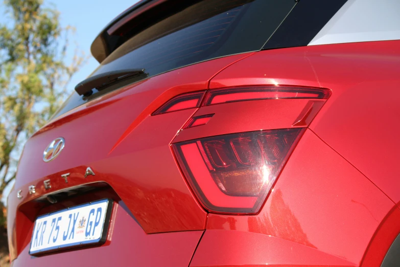 the rear of a red sports car that has been parked