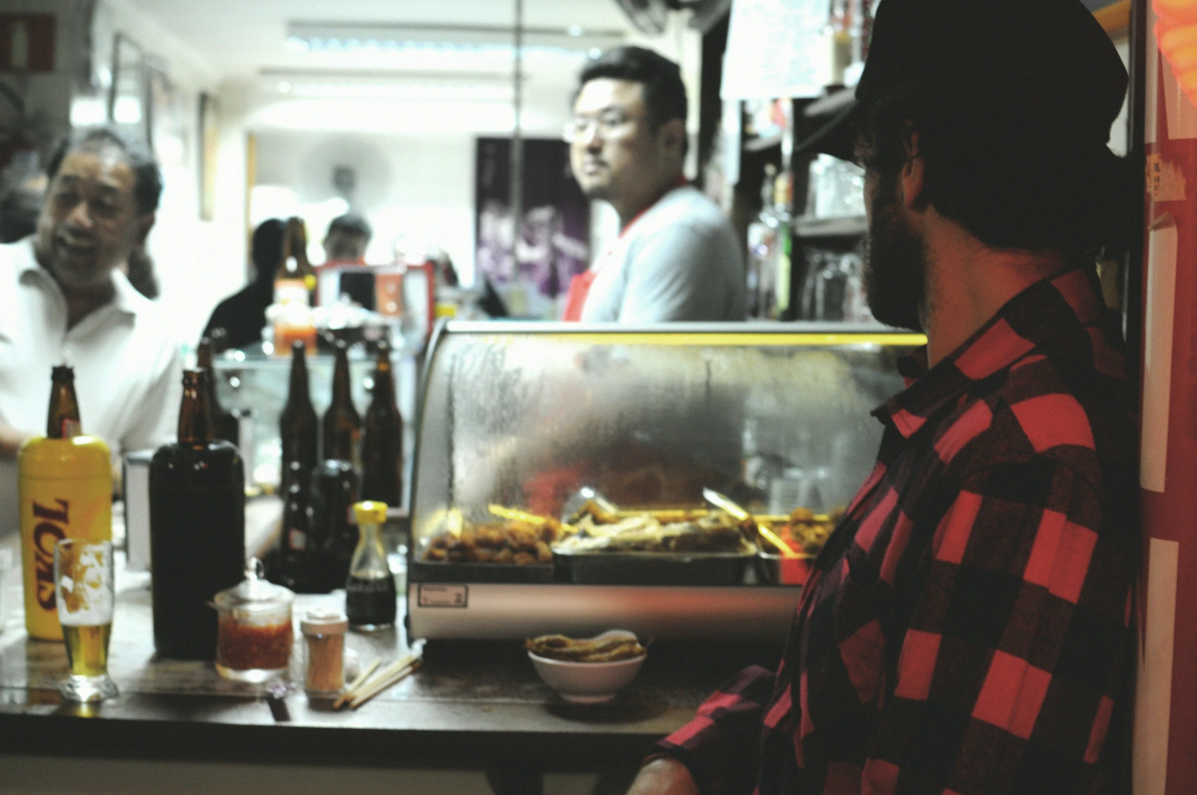 a man sitting at a counter in front of a bunch of people