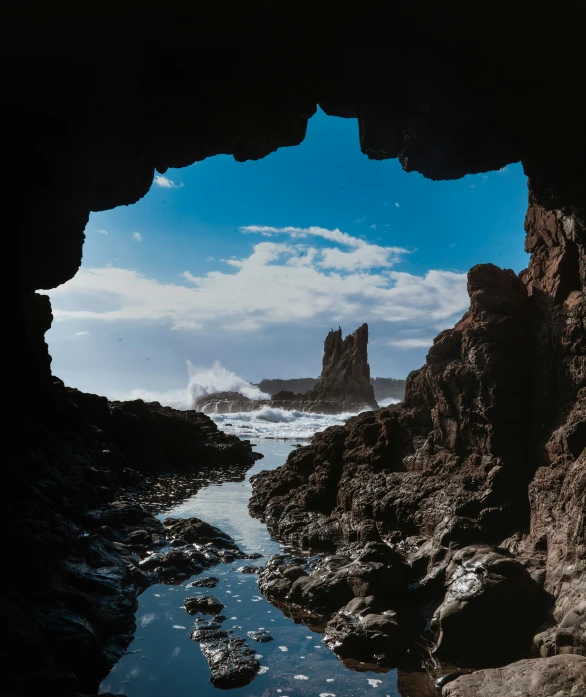 water running under rocks and through a cave