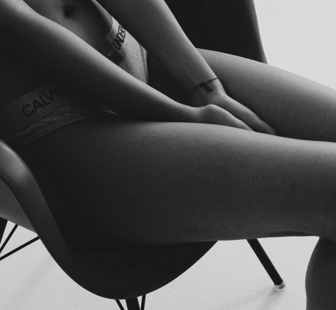 woman's black panties are shown on the leg of a chair