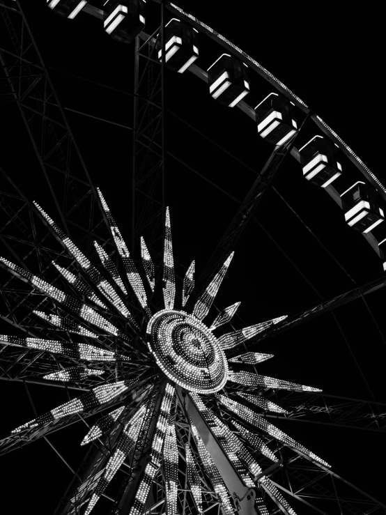 the wheel of an amut park against a black sky