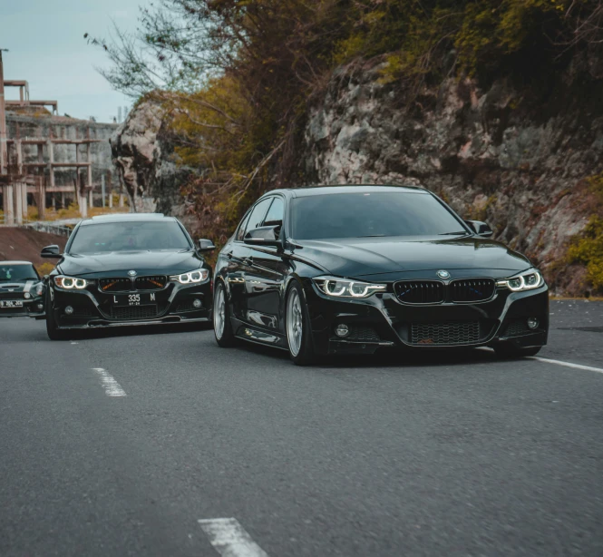 a couple of cars driving down a street