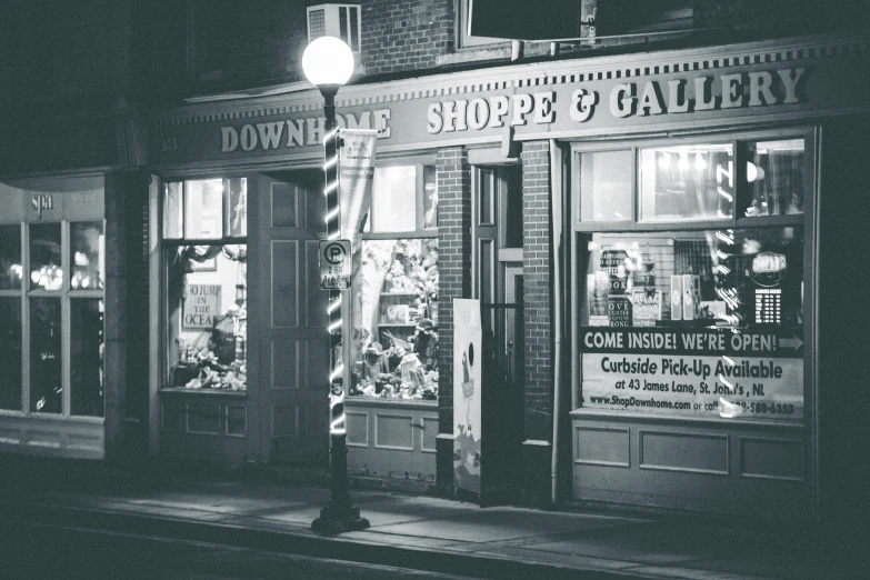 a dark night with a store front and lights on