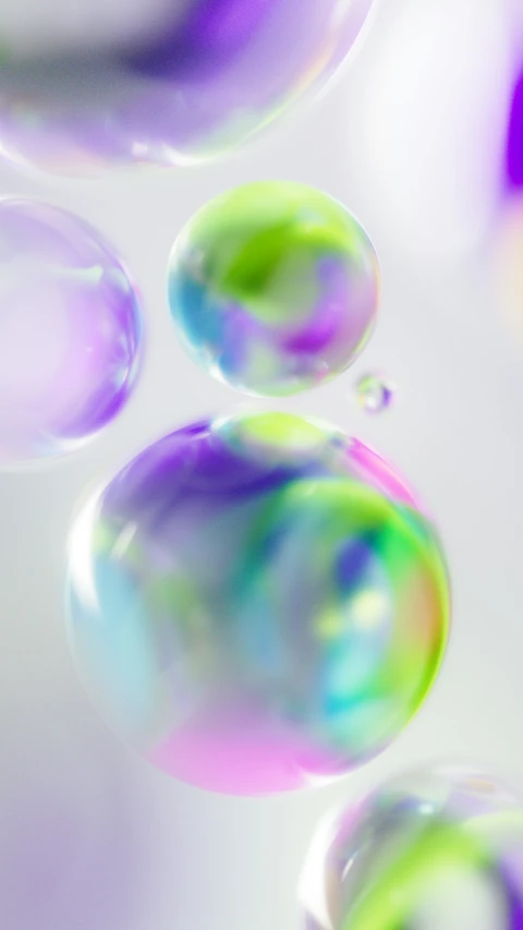 three bubbles of color on the surface of liquid