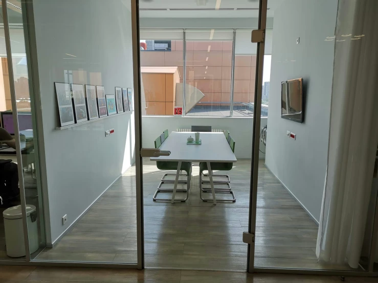 this is an image of a open glass door with white table and chairs