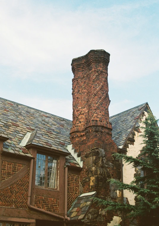 brick fireplace sits next to an old brick home