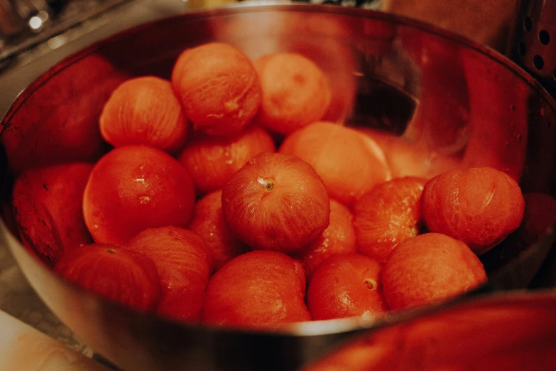 a large metal pan filled with tangerines