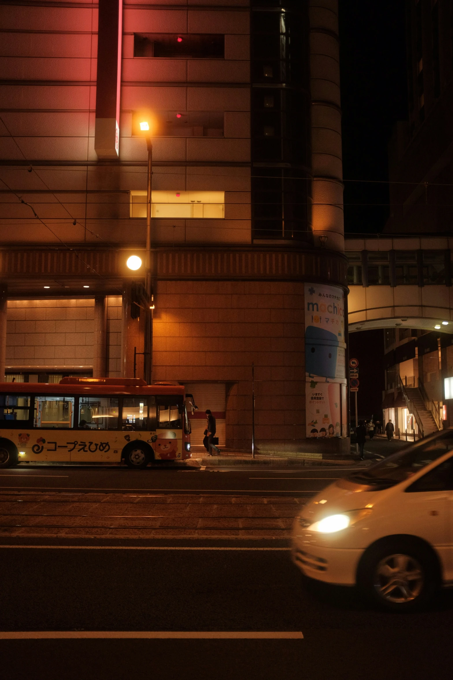 a yellow bus parked on the side of a road next to a building