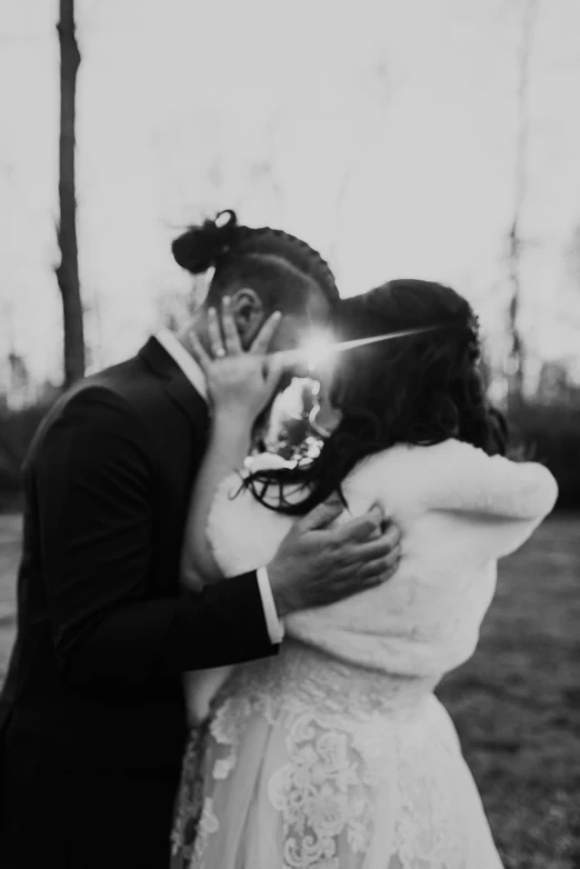 a man and woman in wedding clothes kissing