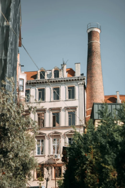 tall brick building with a chimney in the center