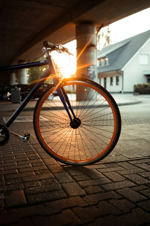 there is a bike parked on a brick sidewalk