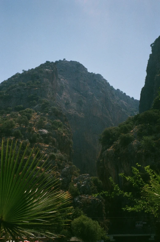 the hills of a tropical island are silhouetted against the blue sky