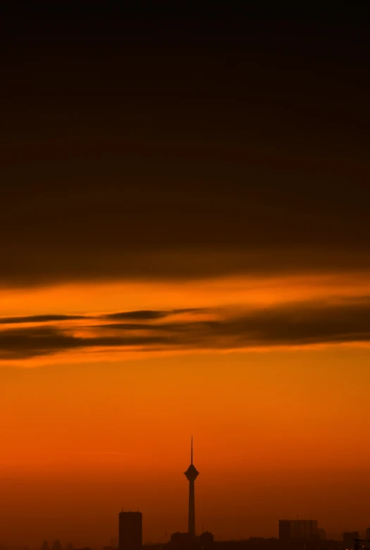 the airplane is flying over the city during sunset