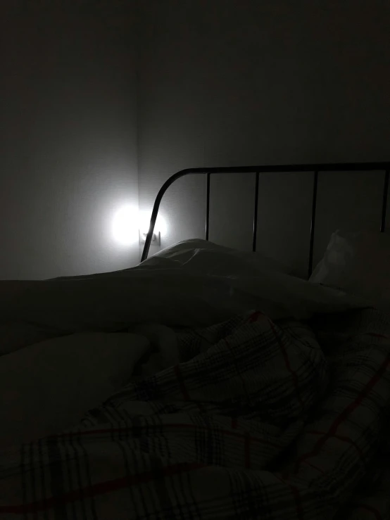 a bed with a blanket and lights on it