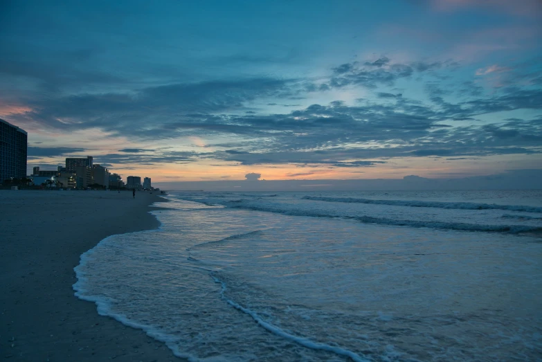 a beach with some buildings in the background