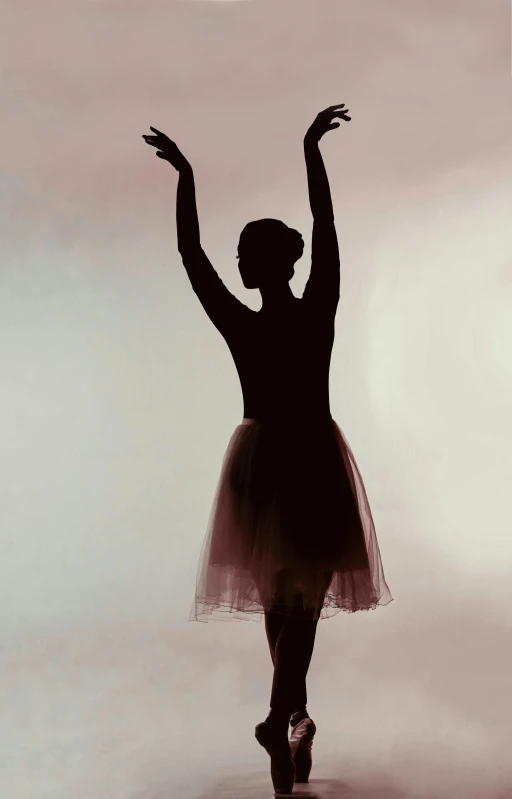 a black and white pograph of a woman in ballet attire