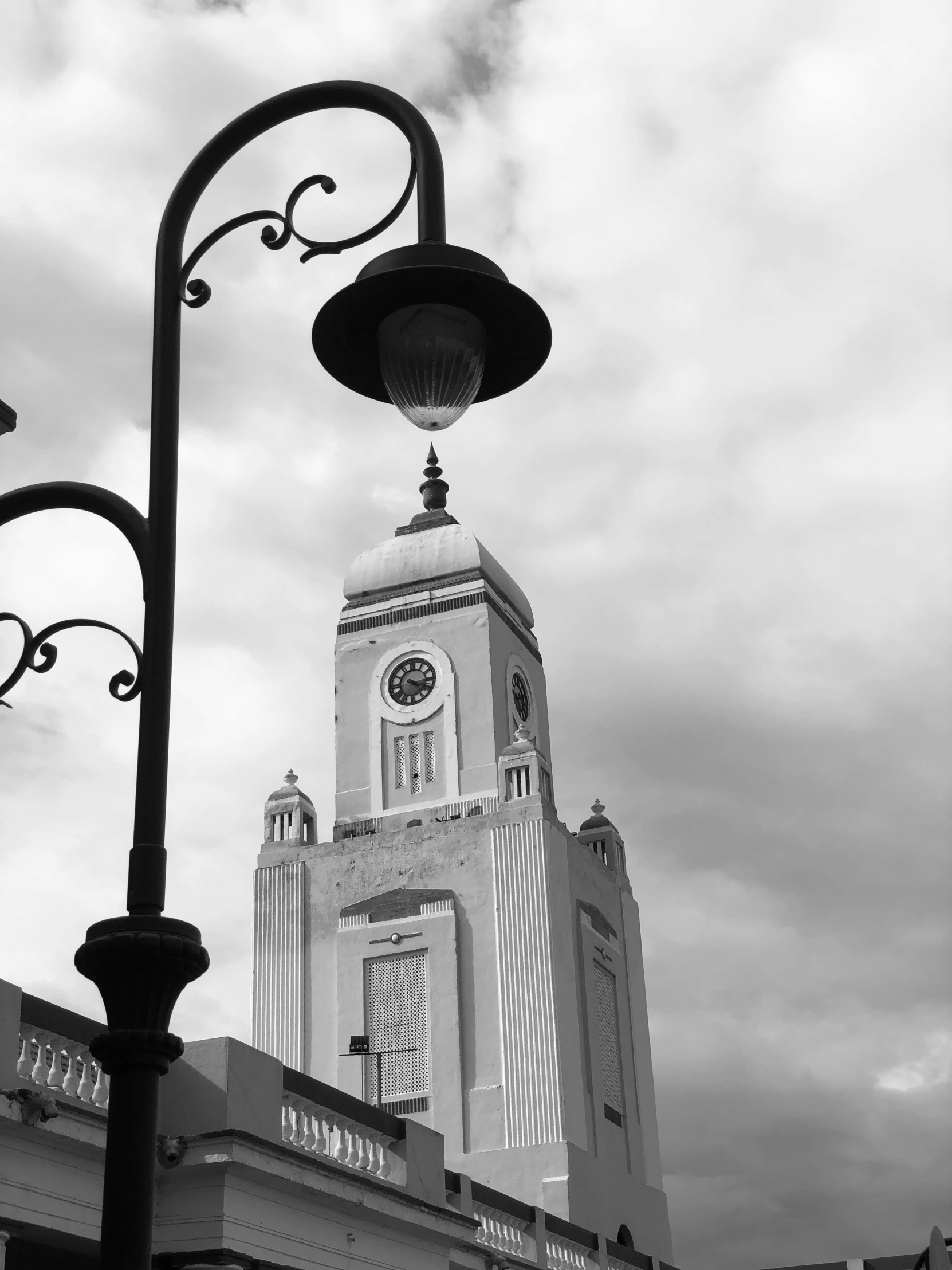 the clock tower is visible above a street light