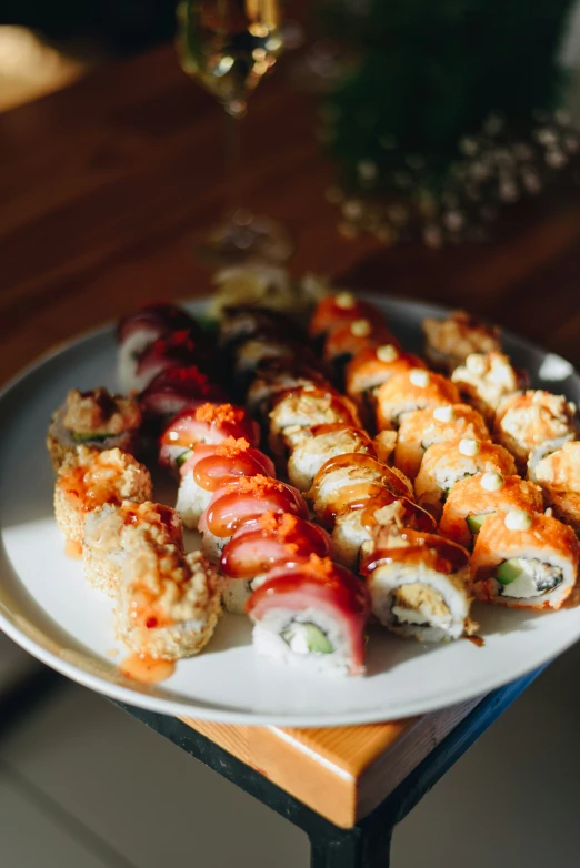 several pieces of sushi on a plate near another plate