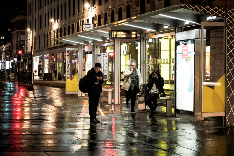 a group of people standing on a wet street