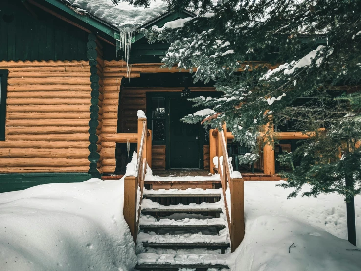 there are stairs leading to the outside of a log cabin
