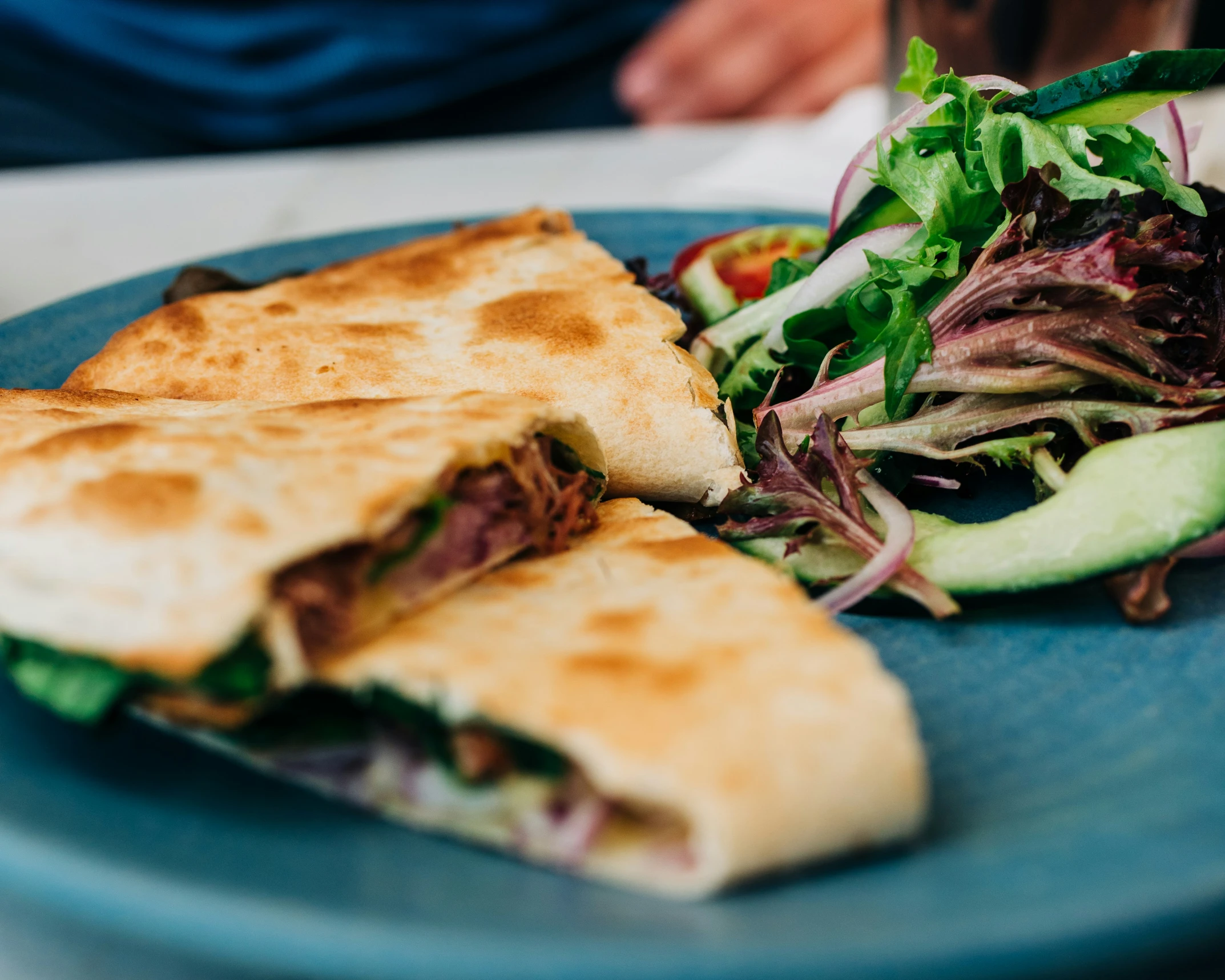 a couple of sandwiches and salad on a plate