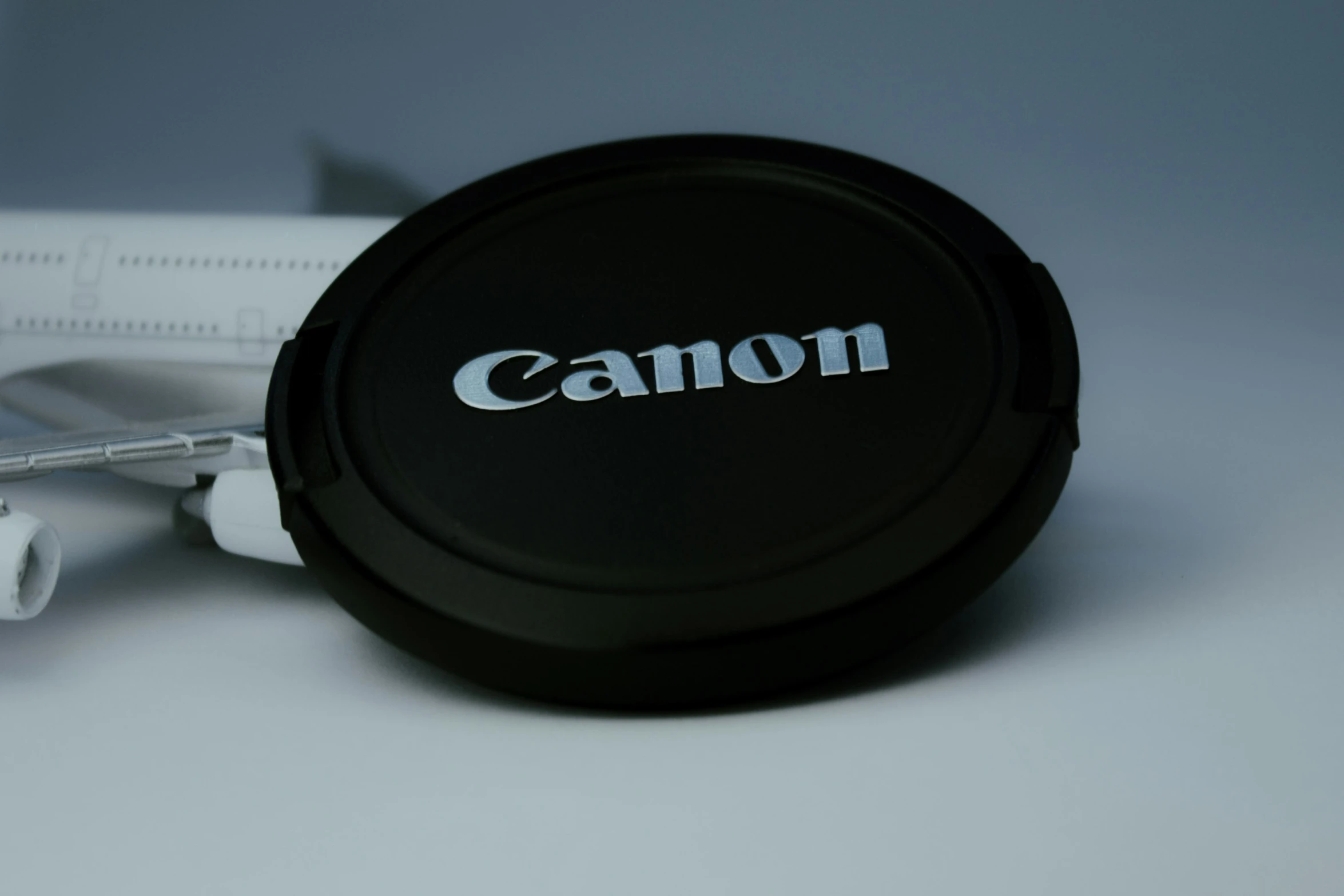 a small plastic object with the word canon written on it