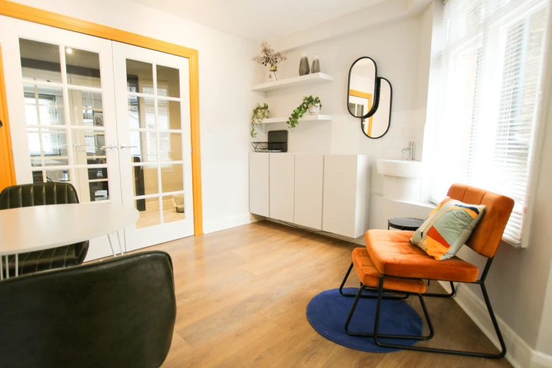 bright apartment with wood floor and white cabinets