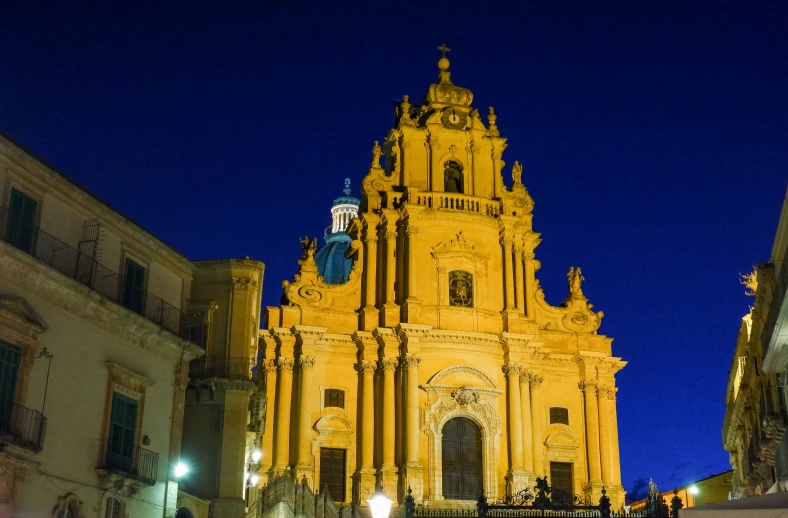 a cathedral is lit up in the night sky