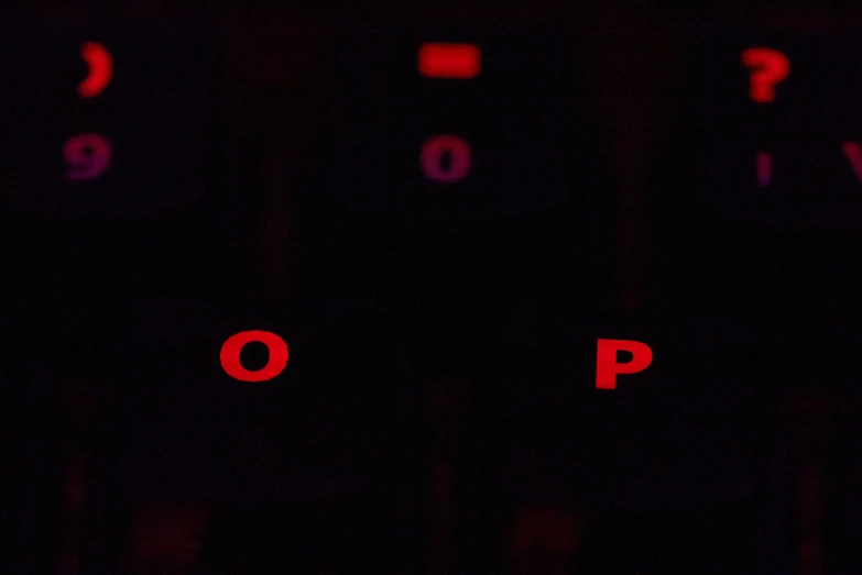 numbers written in red on a dark stage