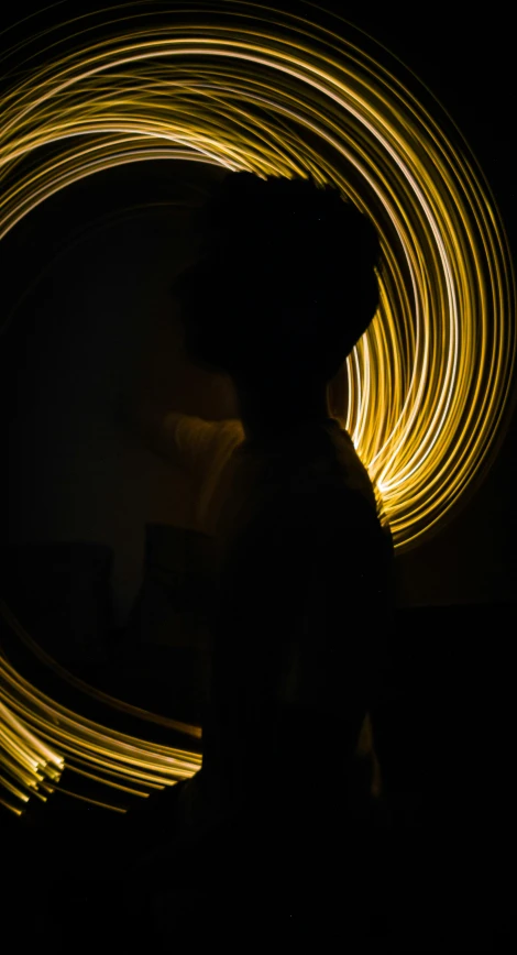 a girl is looking at a ring of light