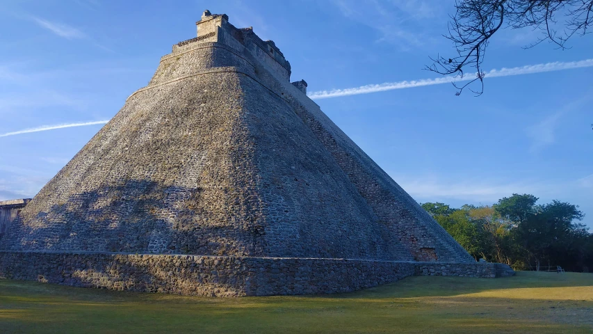 a tall structure sits on a grass field