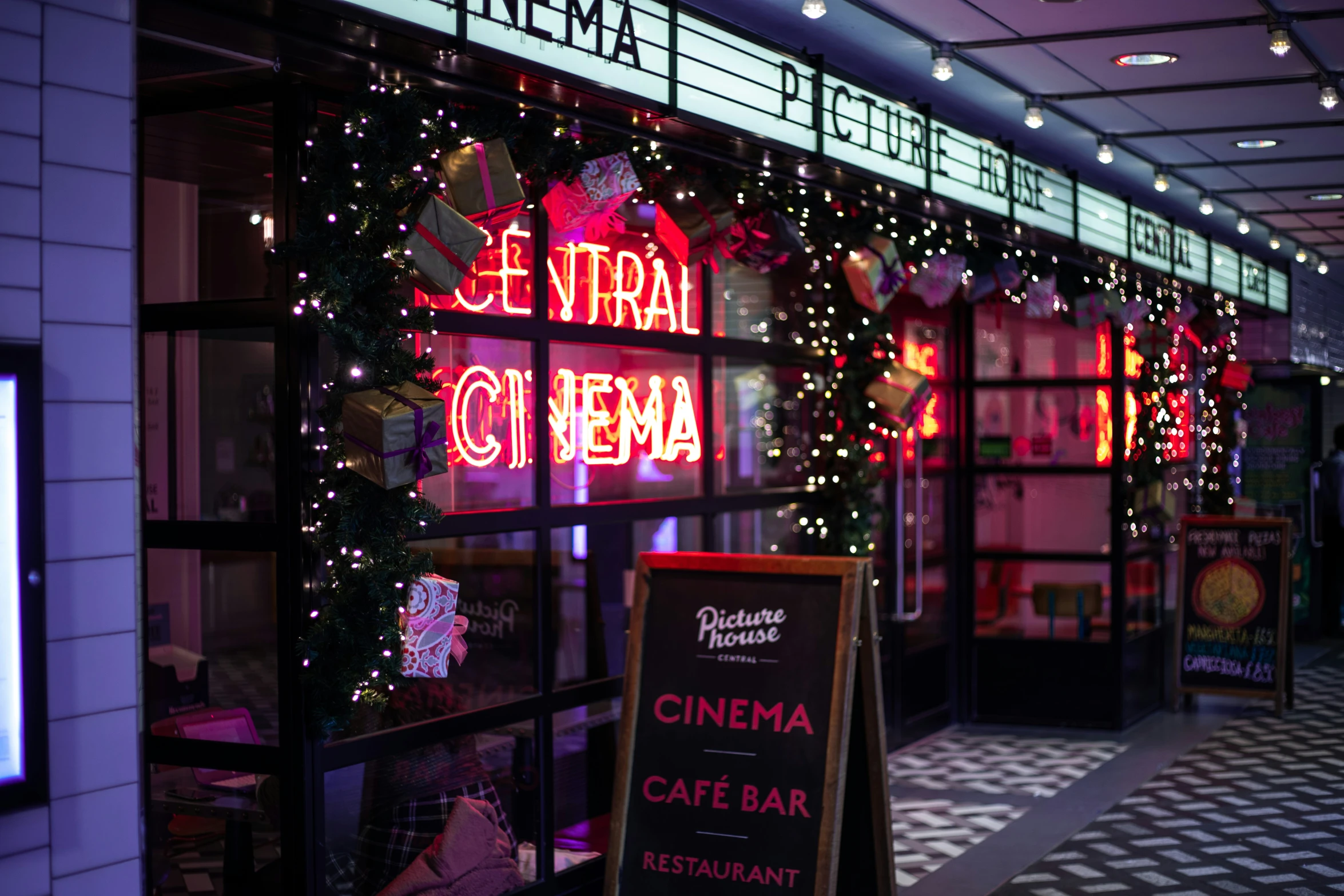 a neon sign in a window outside of a building