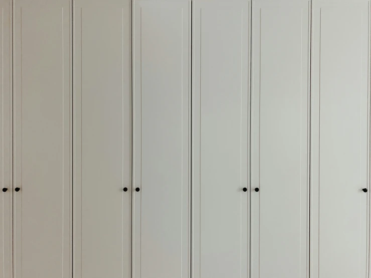 a row of white closets with black ons