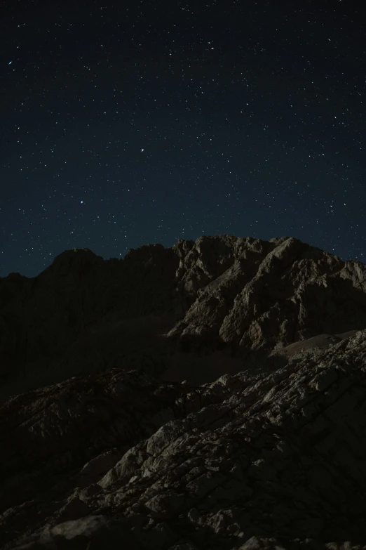 the mountains under a starry night sky