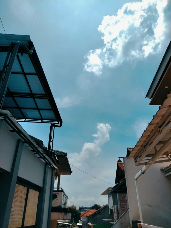 sky and clouds over a city and a row of buildings