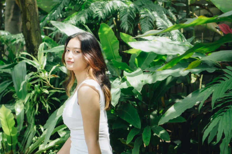 young female in dress in tropical garden setting