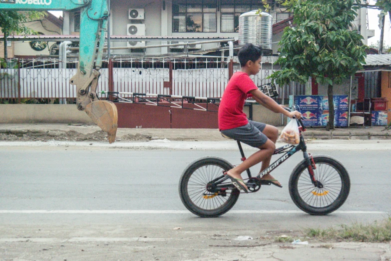 a boy on his bike at the end of a road