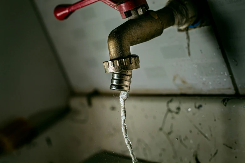 a rusty pipe is shown and water flowing from it