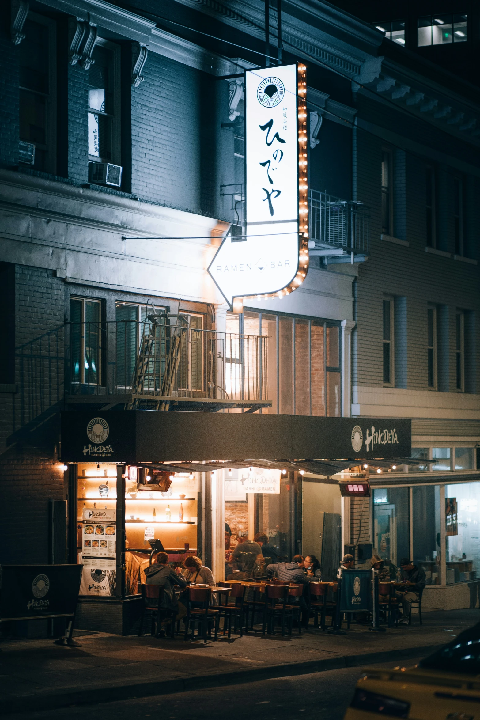 the front of a building with a lit up sign