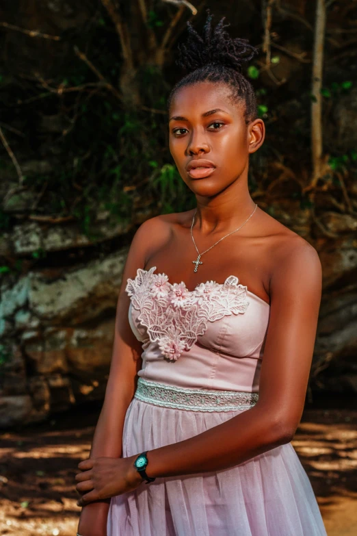 a woman with a ring on her neck and in a pink dress