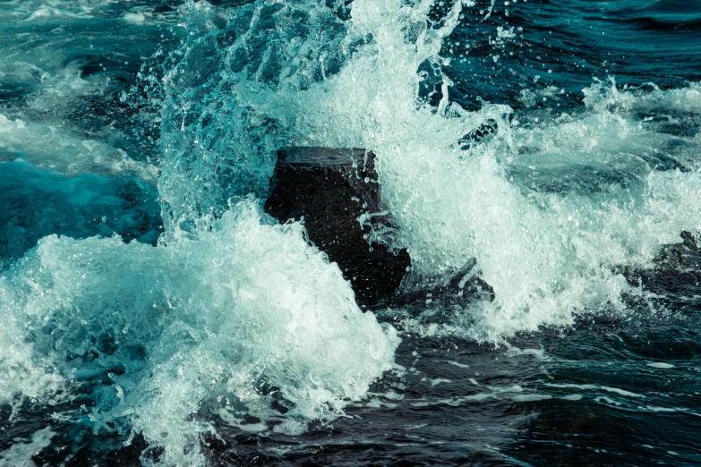 a blue and white po of some waves and rocks