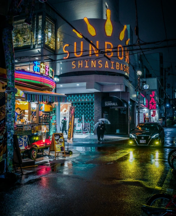 a bunch of signs and umbrellas hanging over a road