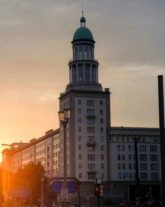 a large building with a green dome is lit by the sun