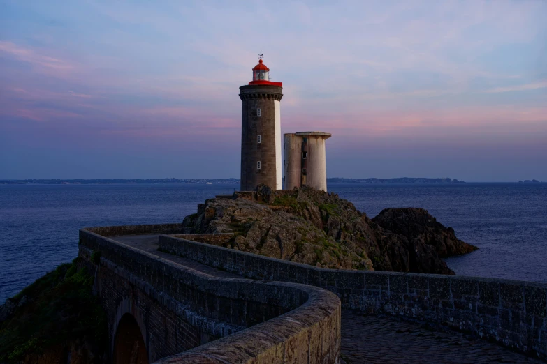 two lighthouses that are at the end of a bridge