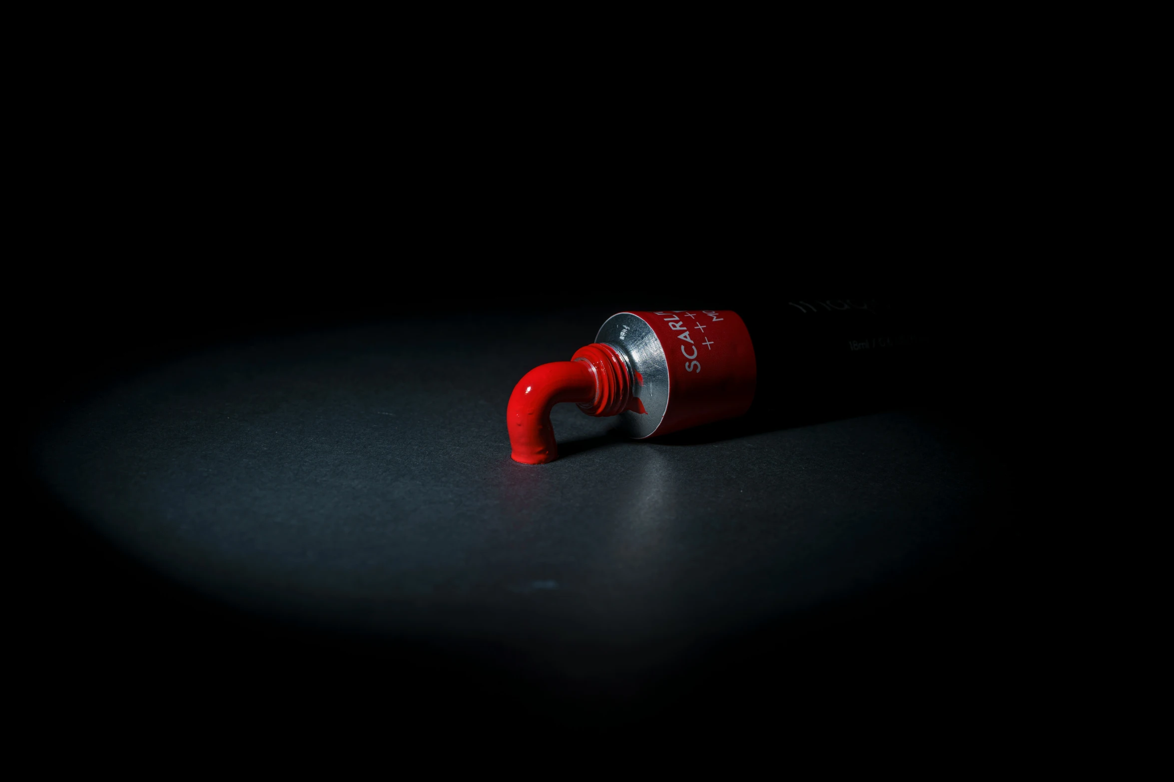 a red screwdriver laying on top of a black table