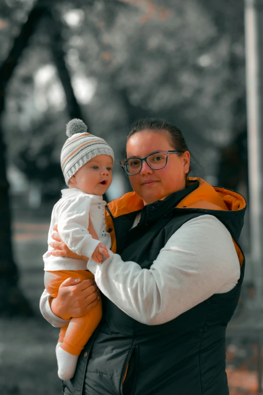 a man holding a baby wearing a knit hat